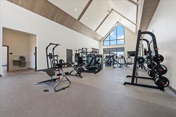 Spacious gym with a variety of equipment including treadmills